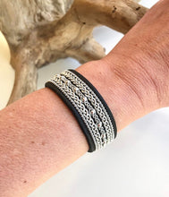 Load image into Gallery viewer, Wide black Scandinavian reindeer leather bracelets, with traditional pewter braiding, sterling silver beads and twisted borders.