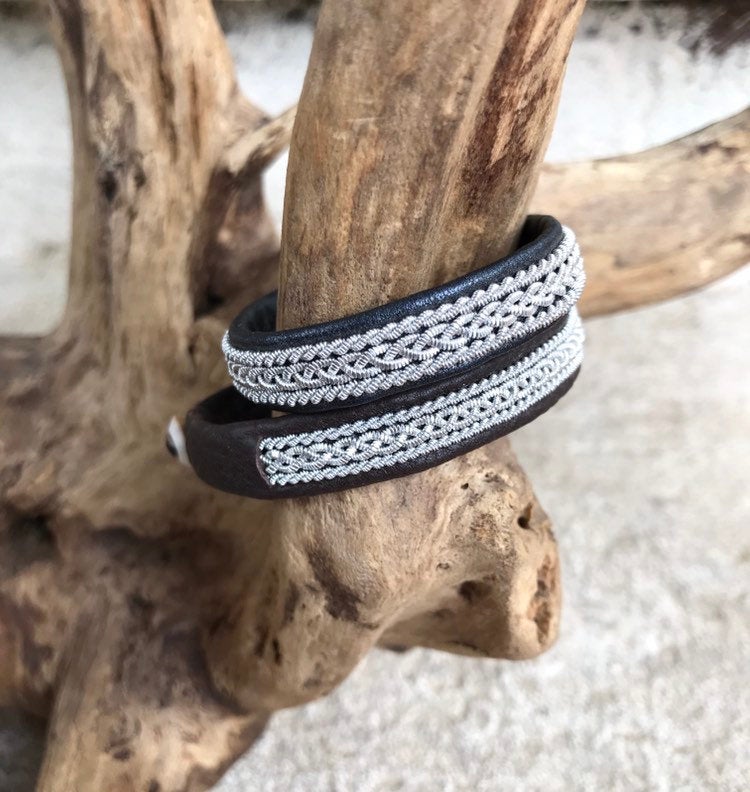 Traditional Swedish Sami reindeer leather bracelets with a braid of flat pewter threads and borders. Black, navy or charcoal - black shimmer.