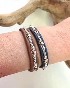 Scandinavian rreindeer leather bracelets with sterling silver beads and rose gold metallic Swarovski crystals. In nougat and navy.