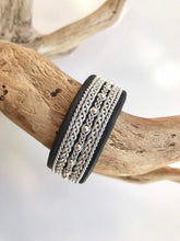 Load image into Gallery viewer, Wide black Scandinavian reindeer leather bracelets, with traditional pewter braiding, sterling silver beads and twisted borders.
