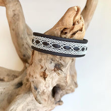 Load image into Gallery viewer, Traditional reindeer leather Sami bracelet, with wider pewter thread braids and pewter Celtic knot button.
