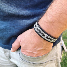 Load image into Gallery viewer, Traditional reindeer leather Sami bracelet, with wider pewter thread braids and pewter Celtic knot button.
