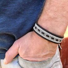 Load image into Gallery viewer, Traditional reindeer leather Sami bracelet, with wider pewter thread braids and pewter Celtic knot button.
